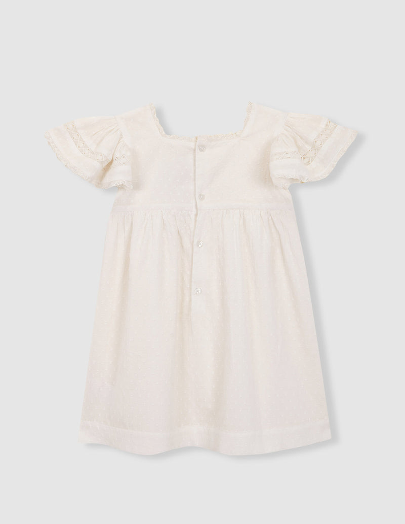 Vestido con jaretas y tiras bordadas